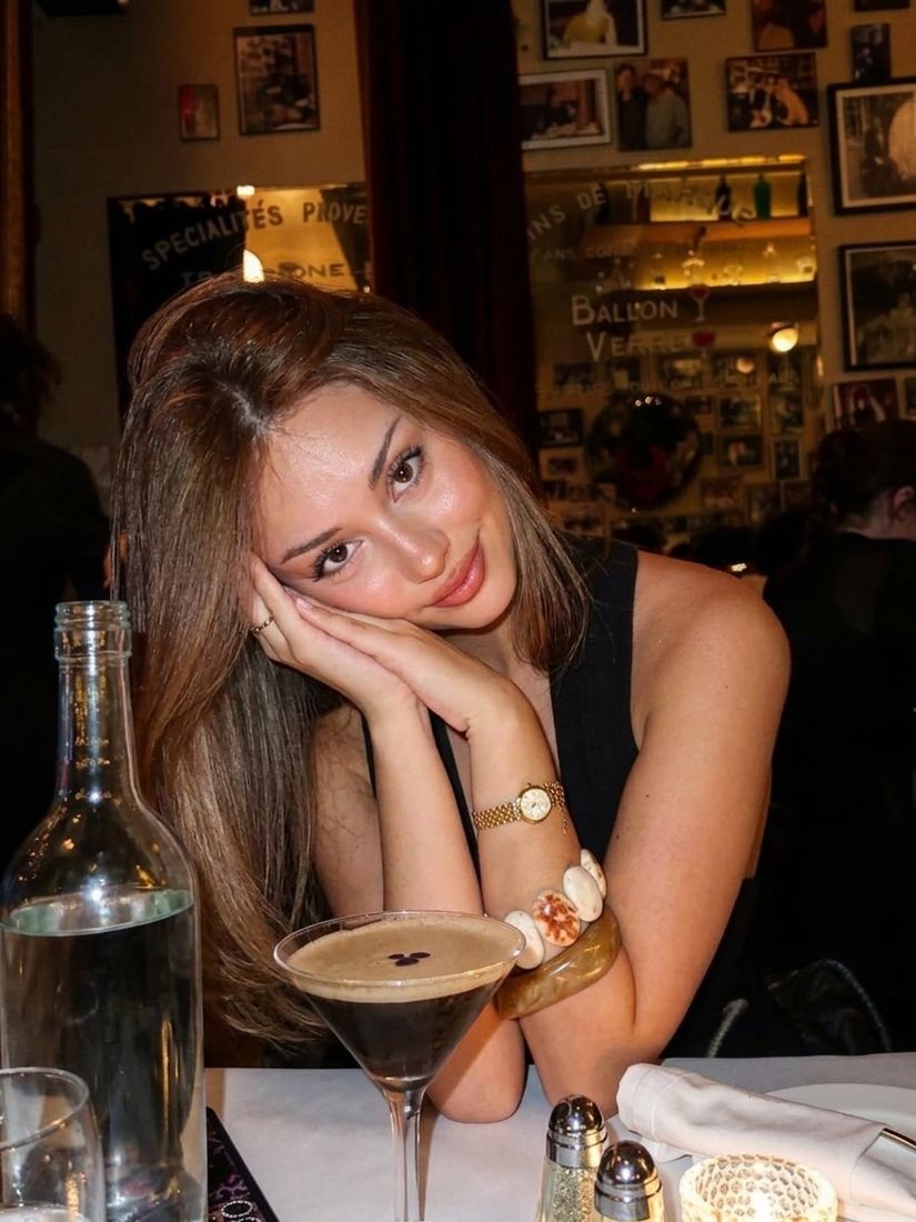 A warm digicam-flash portrait at a restaurant table