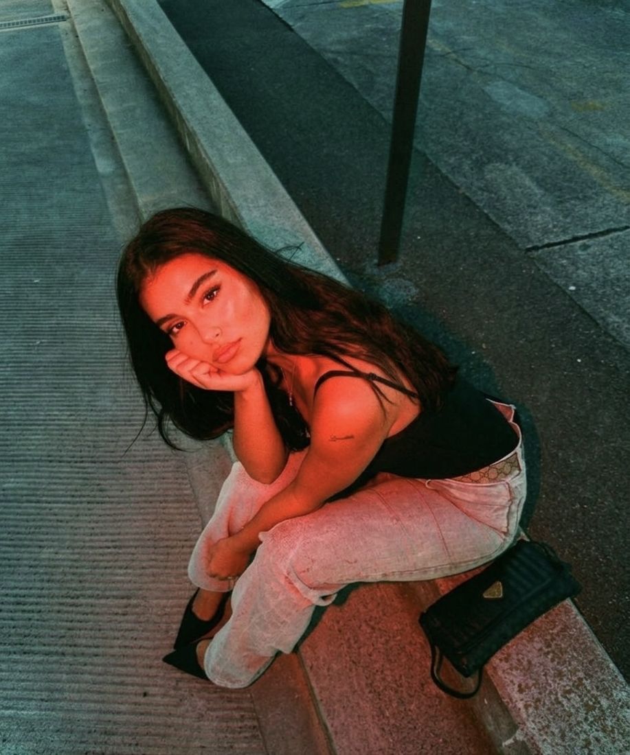 The same portrait on concrete steps lit by vivid red flash
